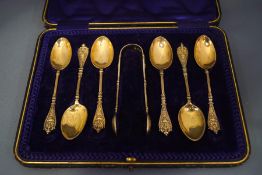 A cased set of six silver gilt tea spoons and sugar tongs, by Holland, Aldwinkle & Slater,