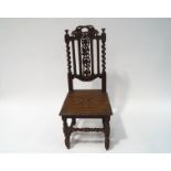 A Victorian oak sidechair with carved and pierced back, solid seat, on turned and carved legs,