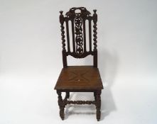 A Victorian oak sidechair with carved and pierced back, solid seat, on turned and carved legs,