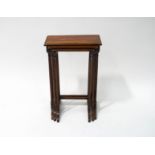 A mahogany nest of three tables with fluted legs and splayed feet, the largest 65cm high,