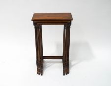 A mahogany nest of three tables with fluted legs and splayed feet, the largest 65cm high,