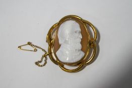 A cameo in gilt metal mount, carved with the profile of a bearded gentleman,