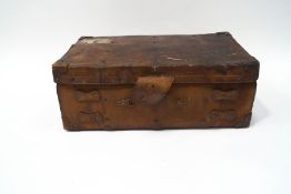 A leather large case with the remains of various luggage labels, 31cm high, 85cm wide, 50.