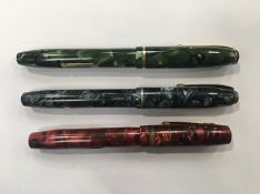Two Conway Stewart fountain pens with blue and green marbled cases, lever filling system,