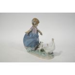 A Lladro figure of a young girl with a goose and her goslings, factory printed marks,