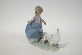A Lladro figure of a young girl with a goose and her goslings, factory printed marks,