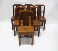 A set of six mahogany and walnut art deco style dining chairs with solid seats and square legs