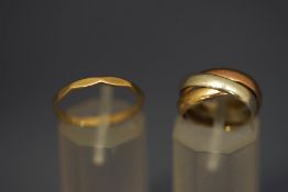 A 9 carat gold three colour 'Russian' wedding ring; and a 9 carat gold ring; 4.