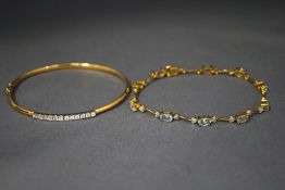 A 9 carat gold cubic zirconia set bangle; and a blue topaz and diamond bracelet; 9.