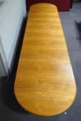 A large 20th century oak boardroom table, the top in three sections, on trestle supports,