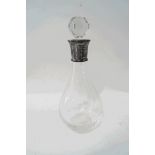 A glass decanter and stopper with silver collar,