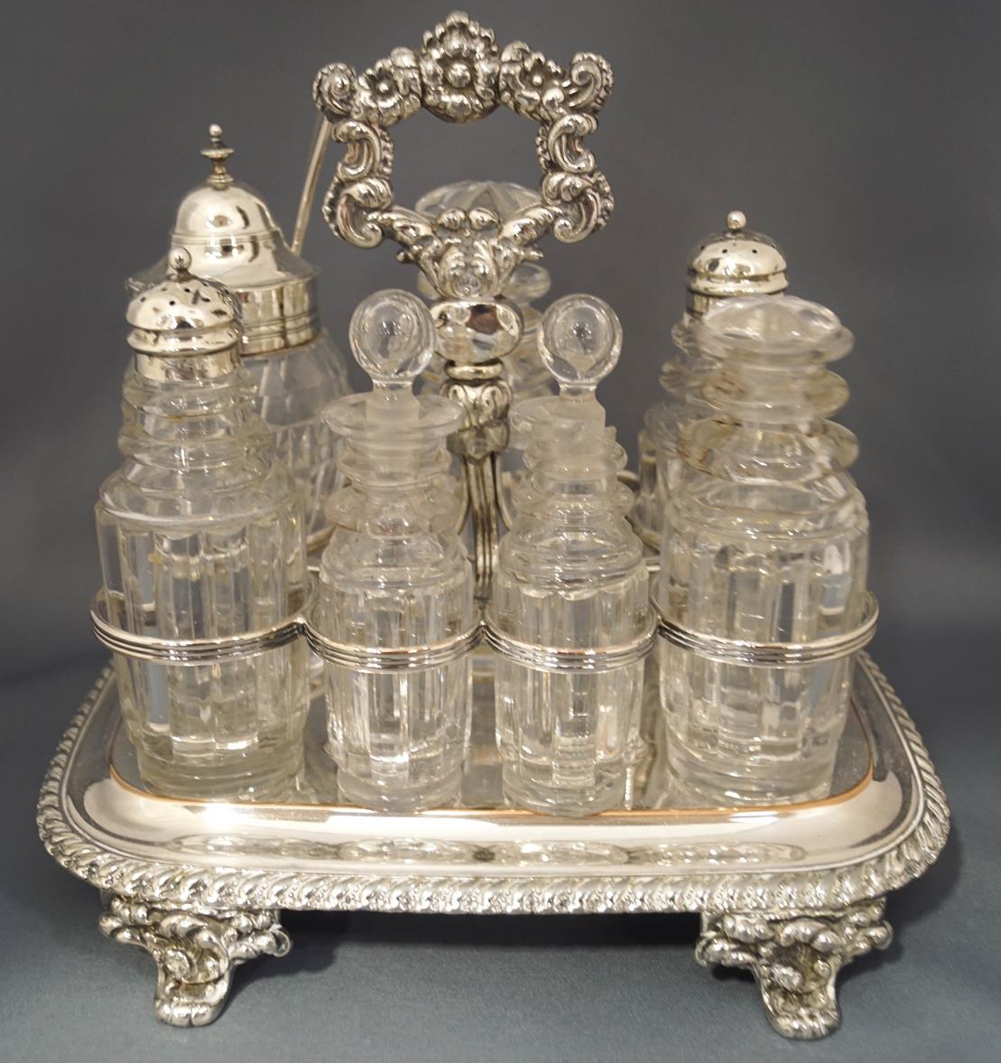 A seven bottle cruet set on a plated waiter,