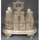 A seven bottle cruet set on a plated waiter,