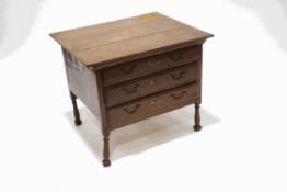 A small oak rectangular table with three narrow drawers, upon turned legs,
