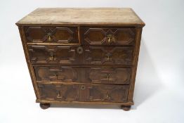 A 17th century style walnut and oak chest of two short and three long drawers with applied moulded