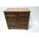 A 17th century style walnut and oak chest of two short and three long drawers with applied moulded