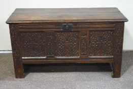 An 18th century oak coffer with interior candlebox, the front,