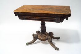 A William IV mahogany card table with leaf carved and turned pedestal on four splayed legs with