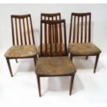 A set of four 1970's G-Plan chairs with shaped vertical rail backs,
