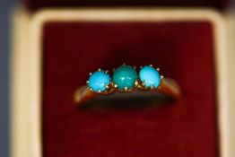 A three stone turquoise ring, stamped '18ct', finger size M, 4.