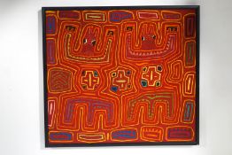 A mid 20th century needlework, possibly Aboriginal, with stylized crocodiles in ebonised frame,