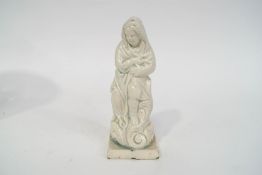 A late 18th/early 19th century Pearlware figure of a child wrapped in a shawl on square plinth,