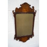 A George II style wall mirror with walnut fret frame and gilded moulding, 93.5cm high x 45.5cm wide.