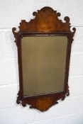 A George II style wall mirror with walnut fret frame and gilded moulding, 93.5cm high x 45.5cm wide.