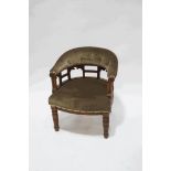 An Edwardian mahogany framed tub shaped chair with button back on turned legs