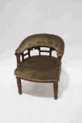 An Edwardian mahogany framed tub shaped chair with button back on turned legs