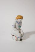 A 19th century Continental porcelain figure of a seated lady with a posy, circa 1840,