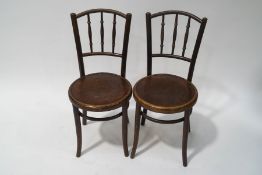 A pair of Fischel bentwood chairs with turned rail backs and impressed seats