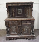 A 17th century style oak court cupboard incorporating 17th century elements with one cupboard door