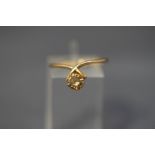 A gold and cognac diamond single stone ring, un-marked, the brilliant cut of approximately 0.