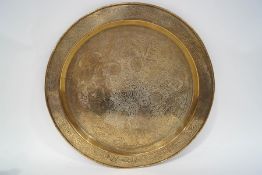 An Indian brass tray with engraved decoration,