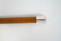 A malacca walking cane with 1 1/4" silver top (rubbed)