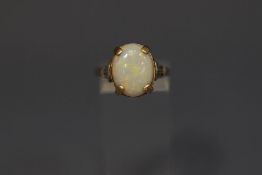 A single stone opal ring, stamped '9ct GOLD' finger size Q, 4.