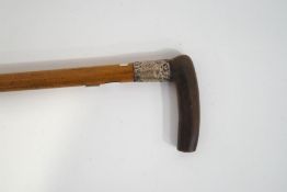 A horn handled walking stick with silver collar,