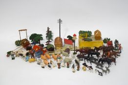A collection of lead figures, mostly farmyard animals, buildings, fences and trees,