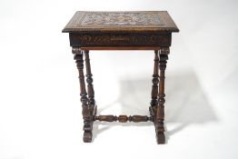 A 19th century continental carved sewing table, the top opening to four sections,