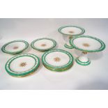 A Worcester dessert service, painted with roses within green bands, comprising eight plates,