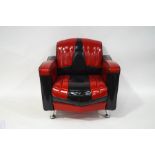 A small Chevrolet armchair with red and black upholstery,