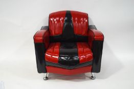 A small Chevrolet armchair with red and black upholstery,