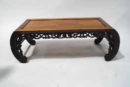 A 20th century Chinese hardwood low table,