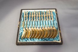 A cased set of twelve white metal apostle spoons, continental, with indistinct marks,