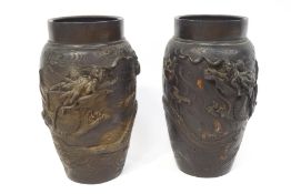 A pair of Japanese bronze vases, each cast with a dragon chasing a flaming pearl, 25.5cm high.