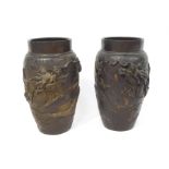 A pair of Japanese bronze vases, each cast with a dragon chasing a flaming pearl, 25.5cm high.