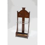 A mahogany hall stand with three chrome hooks above a chrome framed three division stick stand,