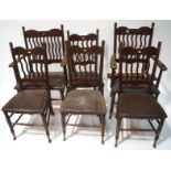 A set of six Edwardian mahogany chairs with unusual vertical line back and leather seats on turned