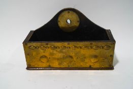 An early 20th century hanging wall pocket with nailed brass panels, inscribed 'A present from S.H.B.